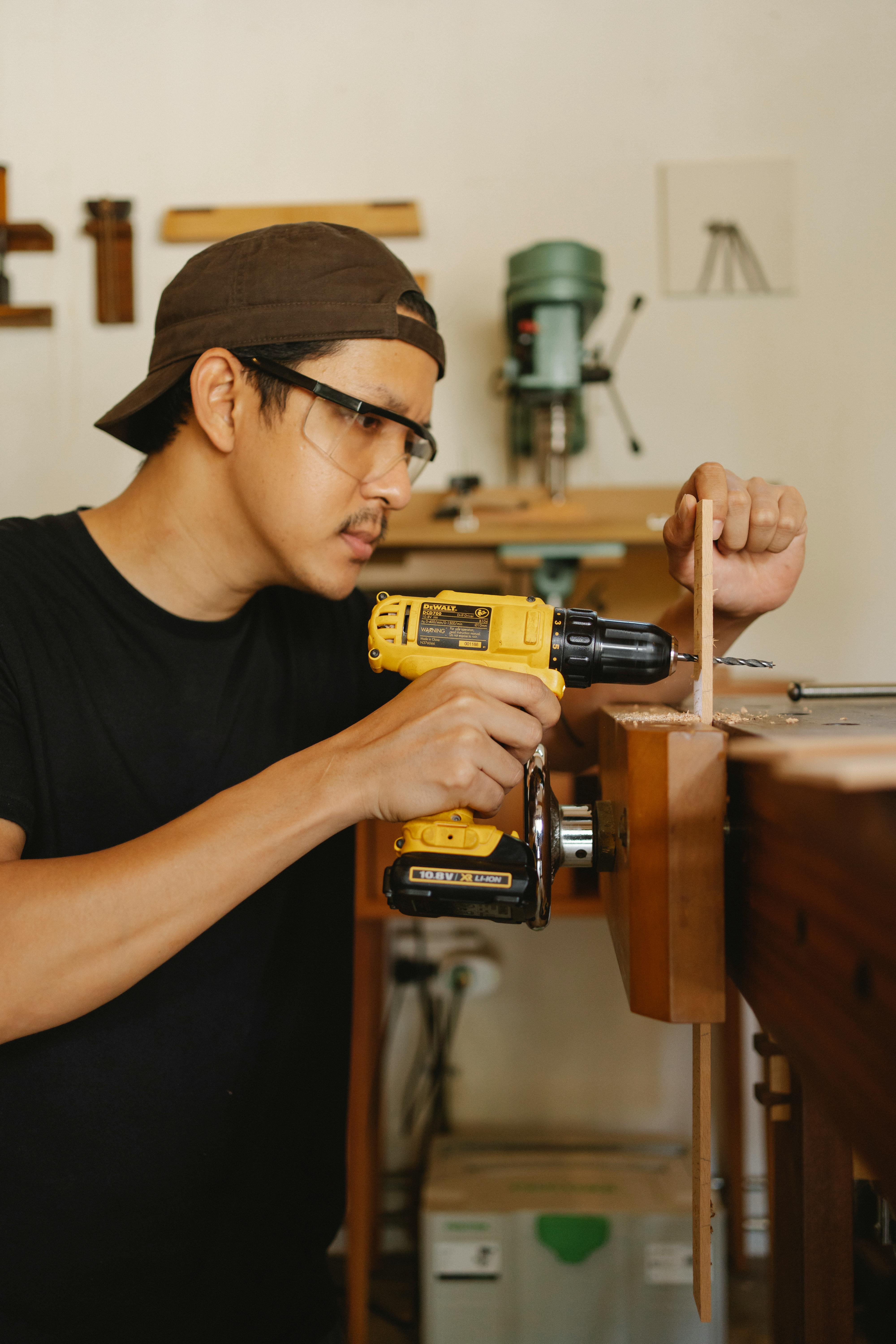 Student using a power drill in a workshop